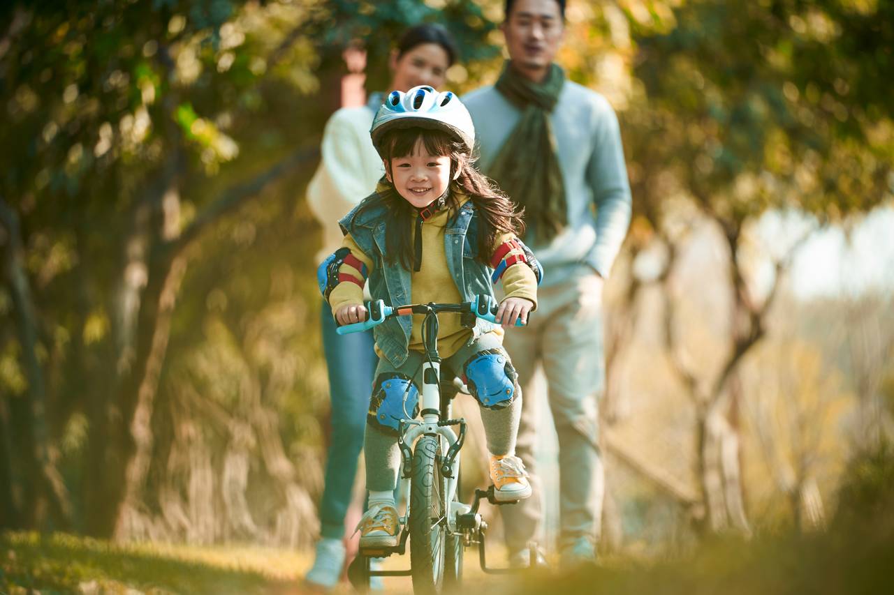parents are taking care of their child in a park