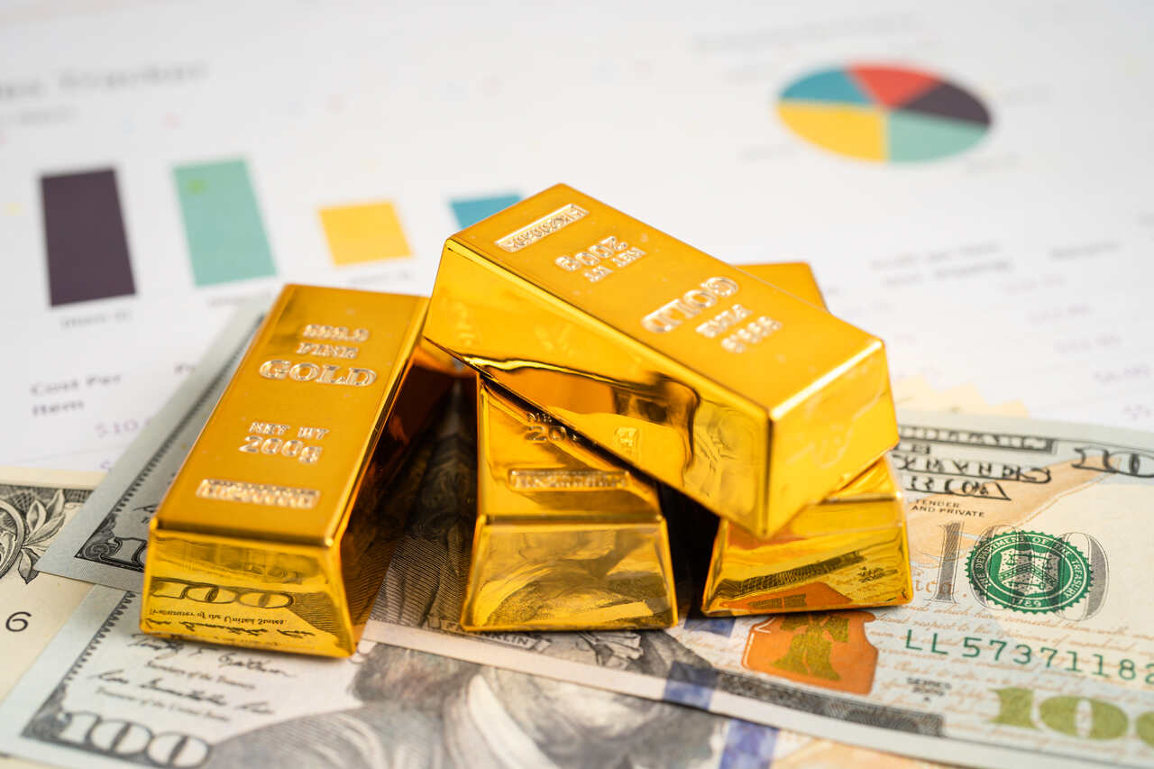 stacks of gold on banknotes on a desk